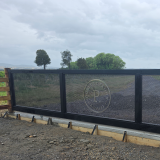 Perforated mesh used as the infill in this custom automatic gate